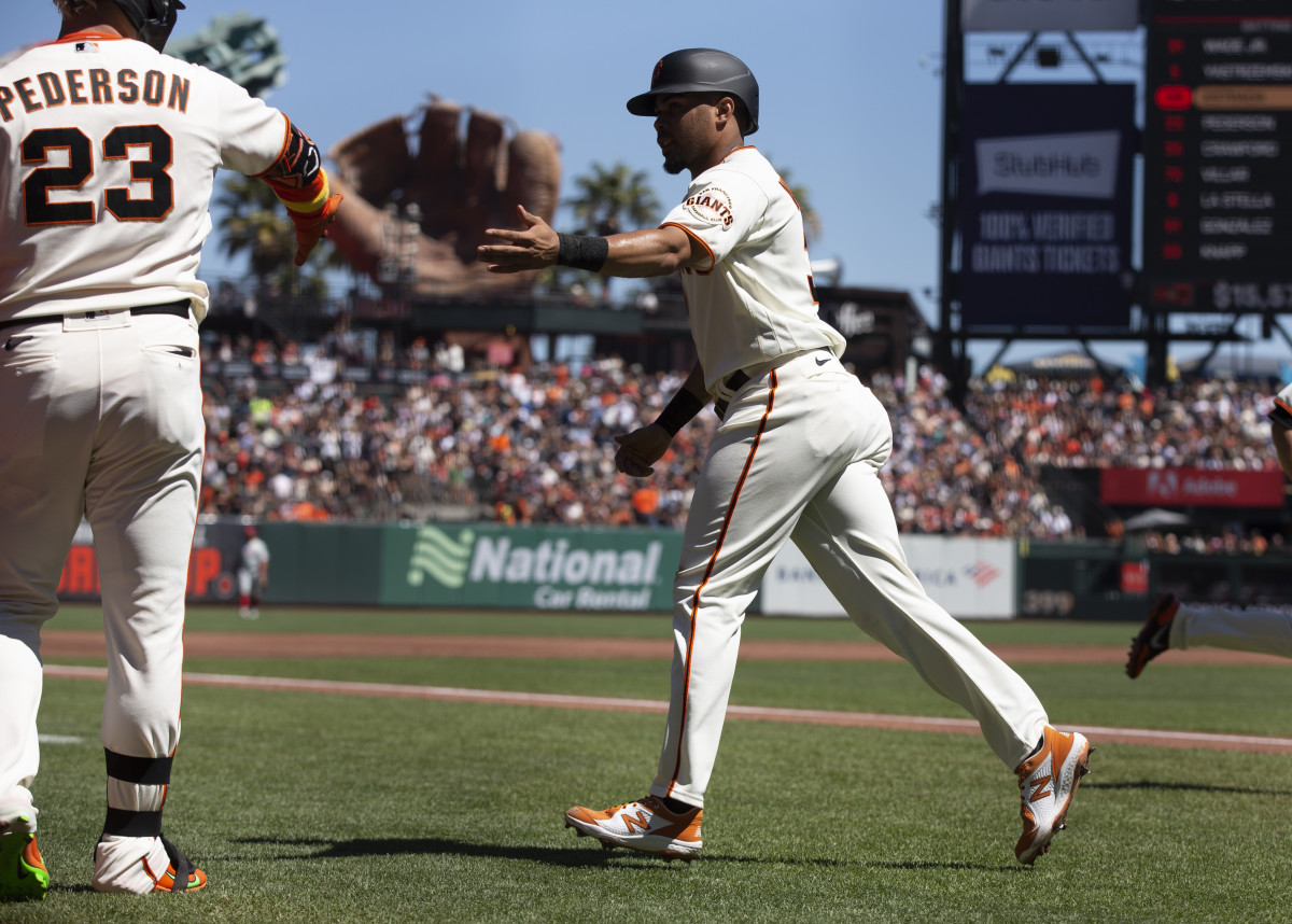 SF Giants first baseman LaMonte Wade Jr. high fives outfielder Joc Pederson